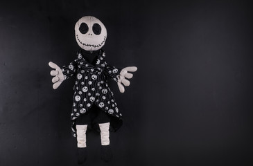 creepy halloween doll on a black background