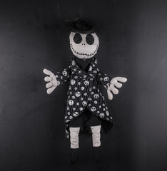 creepy halloween doll on a black background