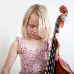 Portrait of a young teenager girl in studio with a cello © jeancliclac