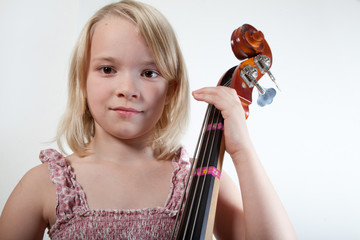 Portrait of a young teenager girl in studio with a cello © jeancliclac