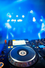 Fototapeta na wymiar Dj playing the track in the nightclub at a party