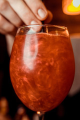 orange aperitif, a cocktail on the wooden table