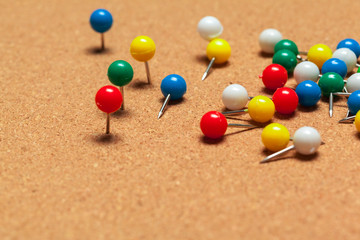 Group of thumbtacks  on corkboard close up. School or business concept