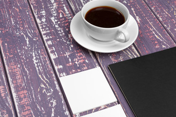 Obraz na płótnie Canvas Mock up set of id template, notebook and cup of coffee. Coffee break background
