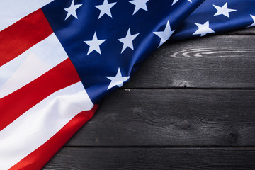 Fototapeta na wymiar USA flag on dark wooden table background