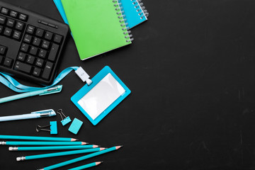 Composition of office supplies and equipment in black and blue colors, top view