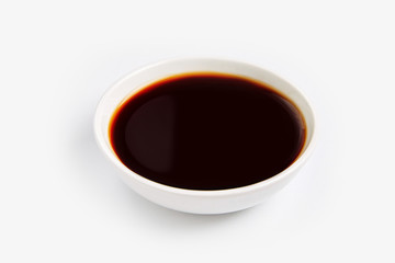 Soy sauce in glass bowl isolated on white background