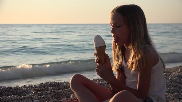 Child Eating Ice Cream on Beach at Sunset, Little Girl on Seashore in Summer 