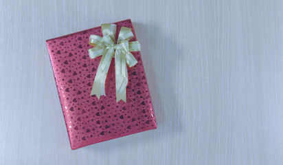 Top view on gift box with bow on wooden background with copy space for Christmas, new year, birthday or Valentine gift. greeting card holidays concept.