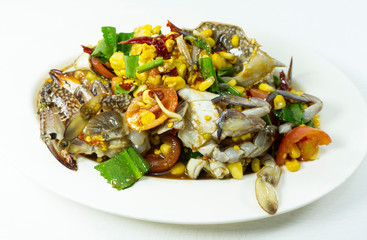 Spicy food with Blue Crab in a white plate on white floor table, Thai foods. Top view Copy Space...