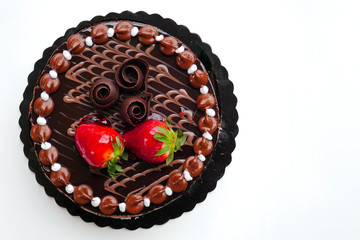 chocolate cake with strawberries on white background, space for typing