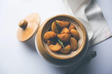 Homemade Gooseberry or amla Pickle/ or Aavle ka Achar in a bowl or barni over moody background.  selective focus