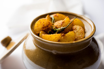 Homemade Gooseberry or amla Pickle/ or Aavle ka Achar in a bowl or barni over moody background.  selective focus