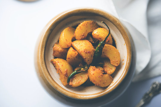 Homemade Gooseberry or amla Pickle/ or Aavle ka Achar in a bowl or barni over moody background.  selective focus