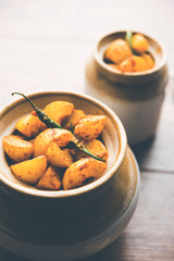 Homemade Gooseberry or amla Pickle/ or Aavle ka Achar in a bowl or barni over moody background.  selective focus