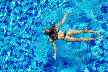 top view resort and spa vacation villa young woman swimming in the pool enjoying a sunny summer day in a tropical paradise top view