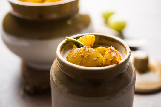 Homemade Gooseberry or amla Pickle/ or Aavle ka Achar in a bowl or barni over moody background.  selective focus