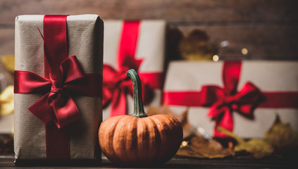 leaves and pumpkin with Halloween gift box on Fairy Ligths background. Autumn season image composition