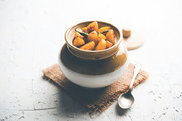 Homemade Gooseberry or amla Pickle/ or Aavle ka Achar in a bowl or barni over moody background.  selective focus