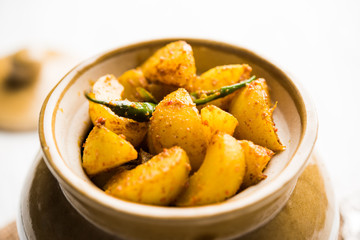 Homemade Gooseberry or amla Pickle/ or Aavle ka Achar in a bowl or barni over moody background.  selective focus