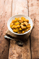 Homemade Gooseberry or amla Pickle/ or Aavle ka Achar in a bowl or barni over moody background.  selective focus