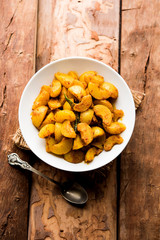 Homemade Gooseberry or amla Pickle/ or Aavle ka Achar in a bowl or barni over moody background.  selective focus