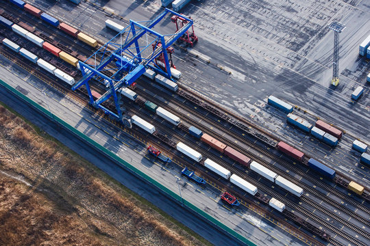 Aerial view of shipping containers being loaded onto a train in shipping terminal. Bremerhaven, Germany