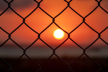 Sunrise through fence