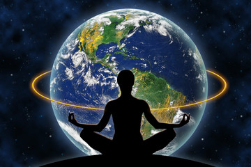 Obraz na płótnie Canvas Female yoga figure against a space background and a planet Earth. Elements of this image furnished by NASA.