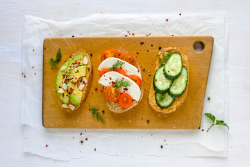 Set of sandwiches served on wooden board