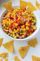 A delicious homemade Mexican salsa with mango, corn, avocado, red onion, lime, cilantro and pepper.