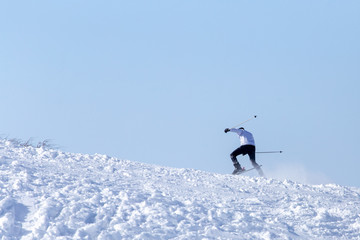 Naklejka na ściany i meble Man skiing in the snow in winter