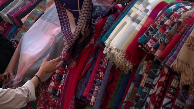 Choosing Traditional Wool Shawl at Kathmandu Market in Nepal