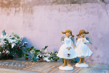 two little angel girls over concrete wall background