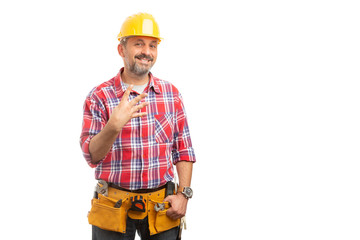 Builder showing number four with fingers.