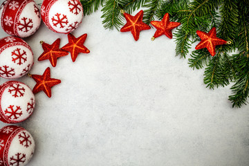 Christmas background with fir tree, red stars and christmass balls.
