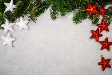 Fototapeta na wymiar Christmas background with fir tree and red shiny stars.