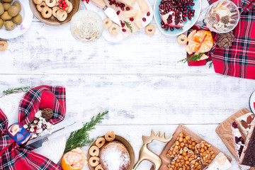 Table with food and snacks for the Christmas party. Table on top. Italian traditional sweets with nuts and nougat and dried fruit. Free space for a copy of the text. Greeting card for the holiday.