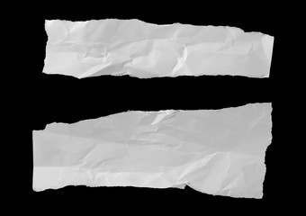 Crumpled white paper scraps isolated on black background