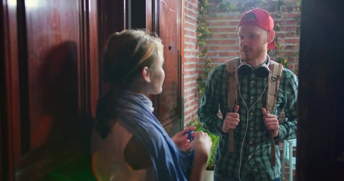 Smiling Cute Couple Talking Standing Opposite Each Other In Doorway