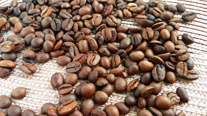 Roasted brown coffee beans on cloth background
