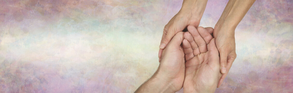 Caregivers Campaign background banner - female hands gently cupped around male cupped hands against a wide subtle multicoloured banner with copy space
