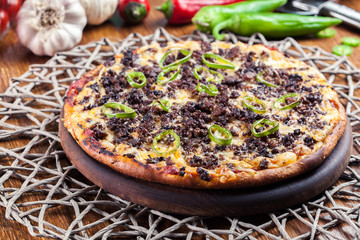 Spicy pizza with minced meat and jalopeno