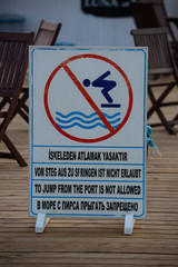 Warning Sign No Diving on a Pier. Cafe on a background