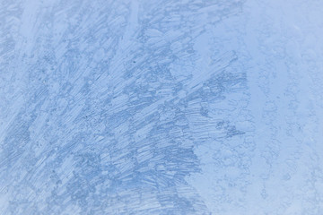 Painted developed frosty patterns on the winter ice window