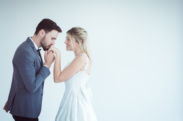 Portrait of groom with bride kissing in her hand on white background,Happy and smiling in engagement day,Copy space and white background