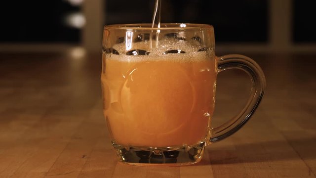 Pour a cold craft beer into a glass in slow motion 4K UHD video 3840x2160