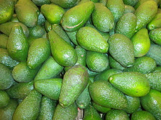 bunch of ripe fresh fruits of avocado in the market