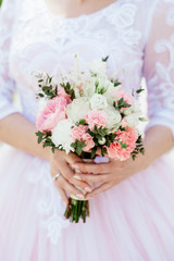 Fototapeta na wymiar bride holding a bouquet of flowers in a rustic style, wedding bouquet. Soft focus