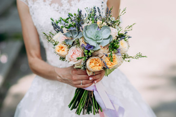 bride holding a bouquet of flowers in a rustic style, wedding bouquet. Soft focus